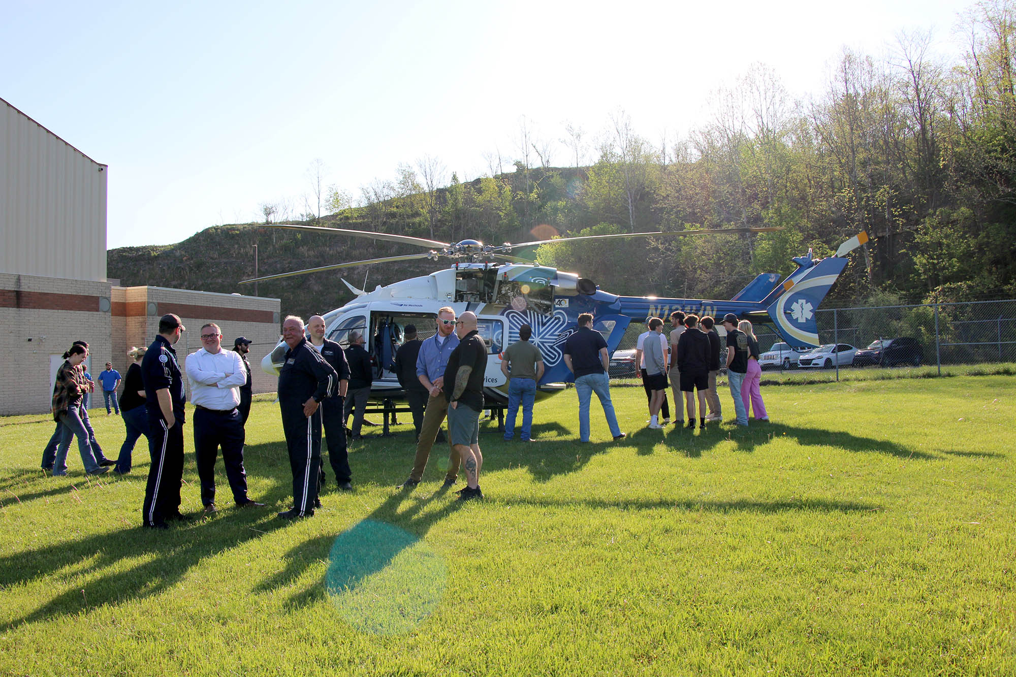 Students gather around a HealthNet Aeromedical Services helicopter after a special landing outside the Robert C. Byrd National Aerospace Education Center during Pierpont Community and Technical College’s Aviation Technology Career Fair on Thursday, April 23, 2026, in Bridgeport, W.Va.