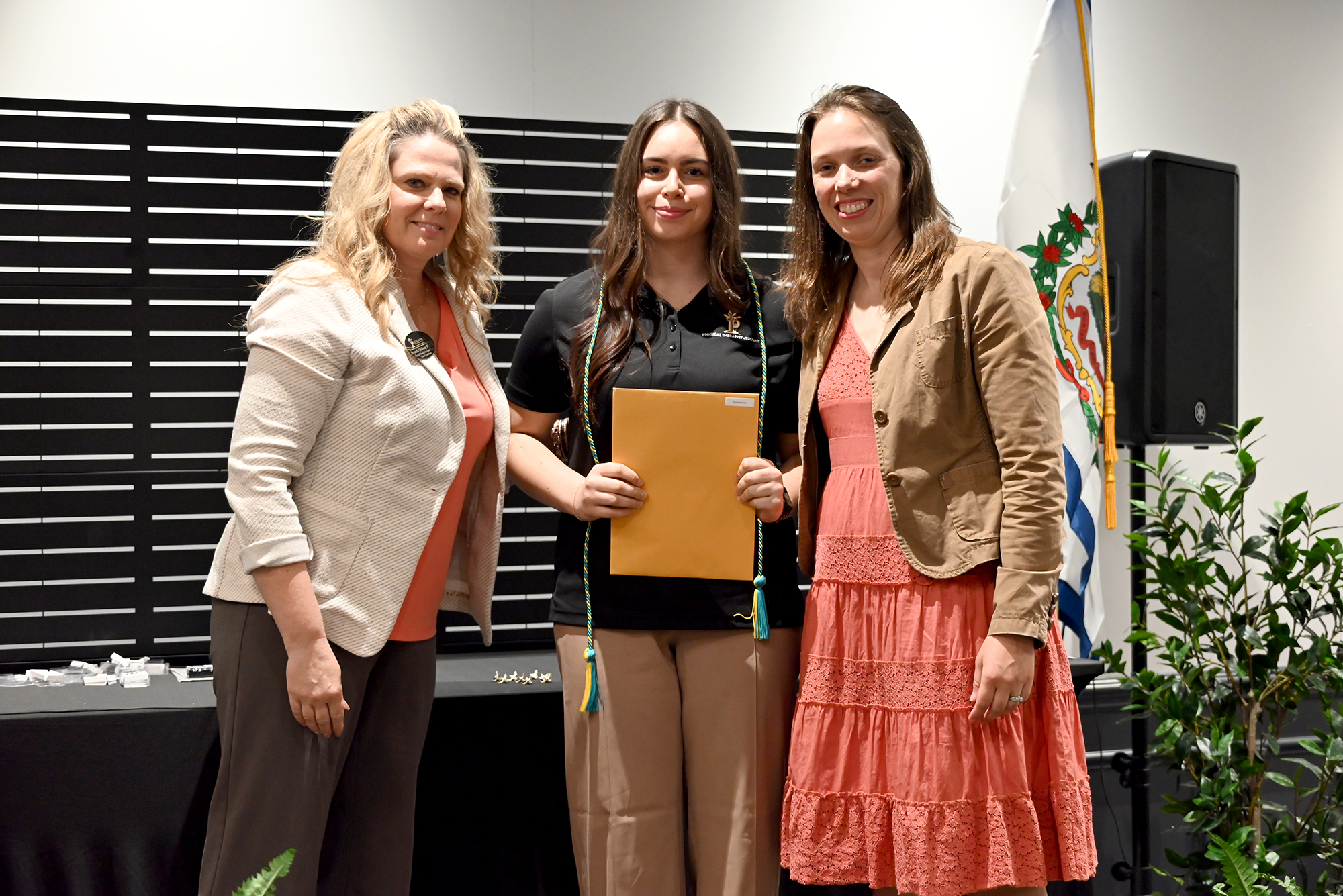 Physical Therapist Assistant program faculty Bryanna Ordiway and Andrea Wamsley-Barr pose with a student following the pinning, marking the completion of academic and clinical training.